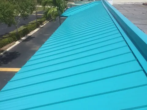 Turquoise standing-seam metal roof on a commercial building